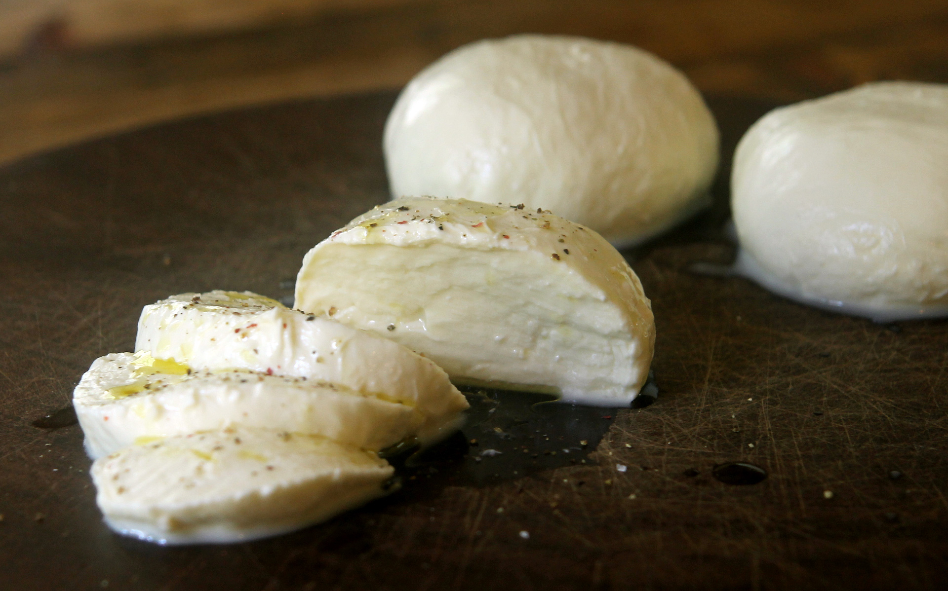 Homemade fresh mozzarella with olive oil and freshly ground pepper.
