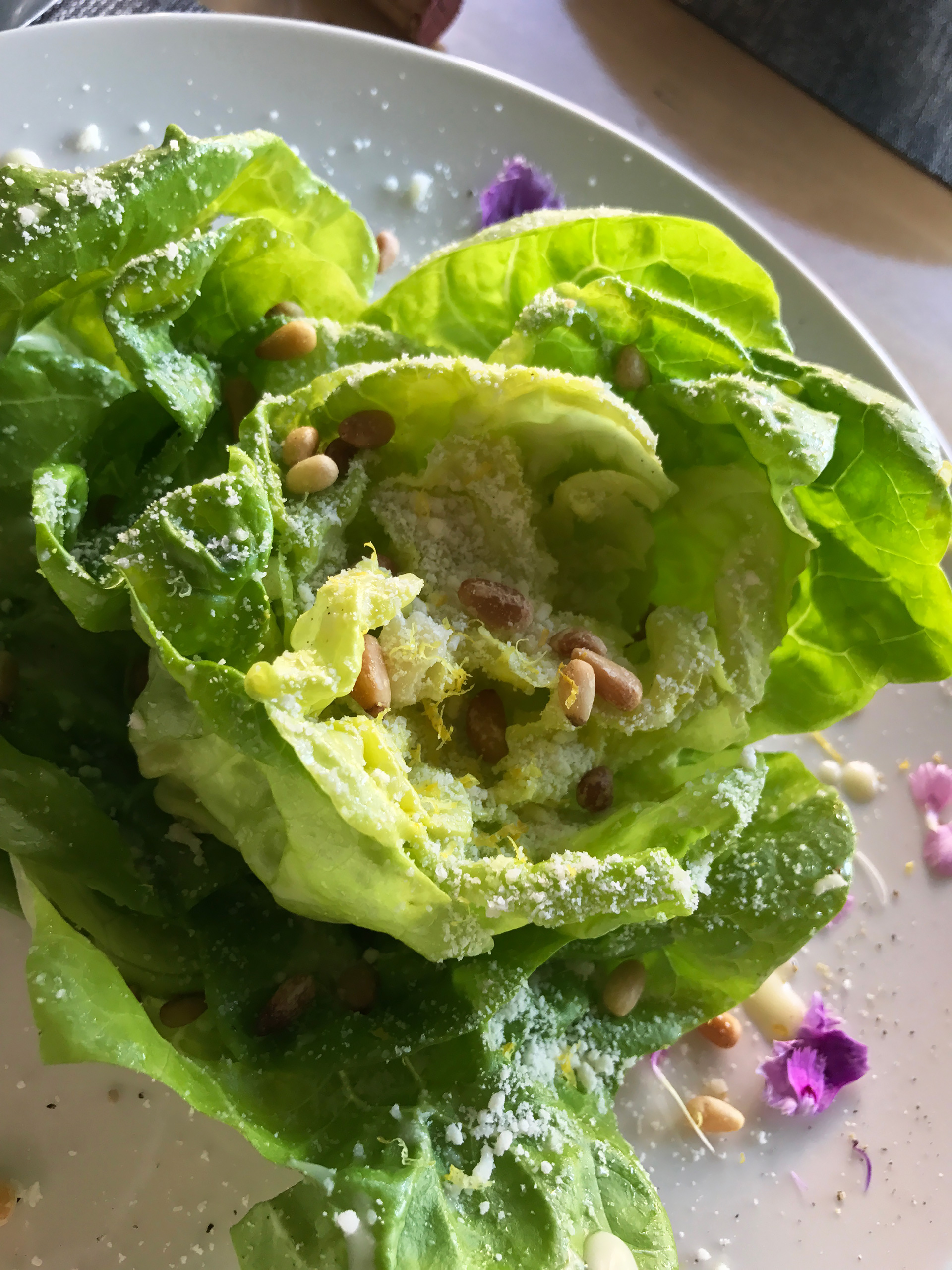 Butter lettuce salad with lemon dressing, grated Grana Padano cheese and roasted pine nuts.