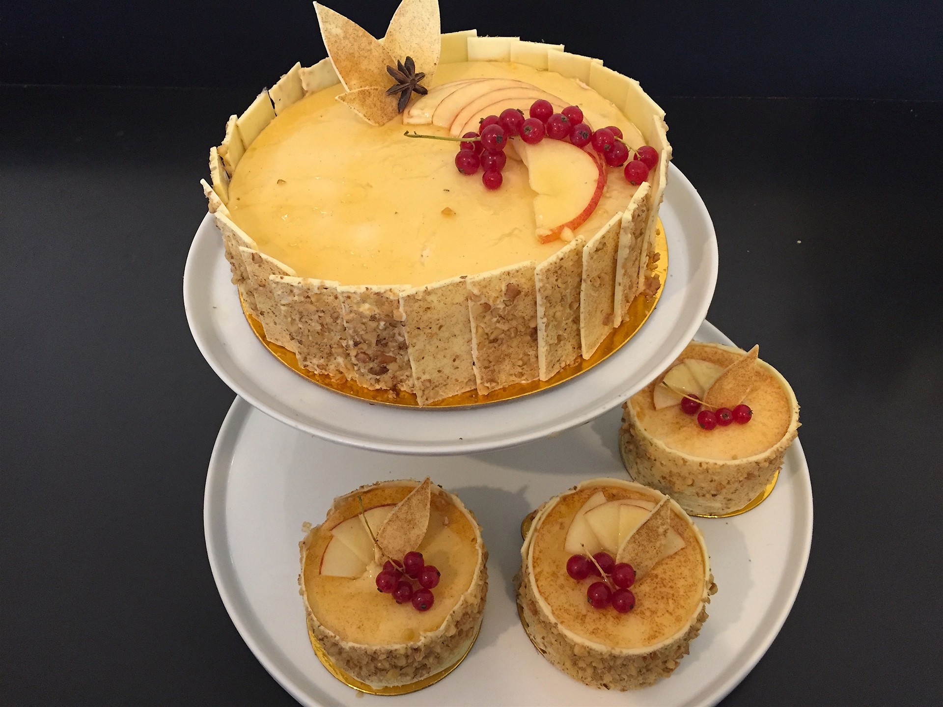 Masse's Pastries'  G/F apple walnut torte has layers of walnut almond sponge cake, sautéed apple compote and lightly spiced honey mascarpone Bavarian creme, encircled by a band of white chocolate, available in large and individual sizes.