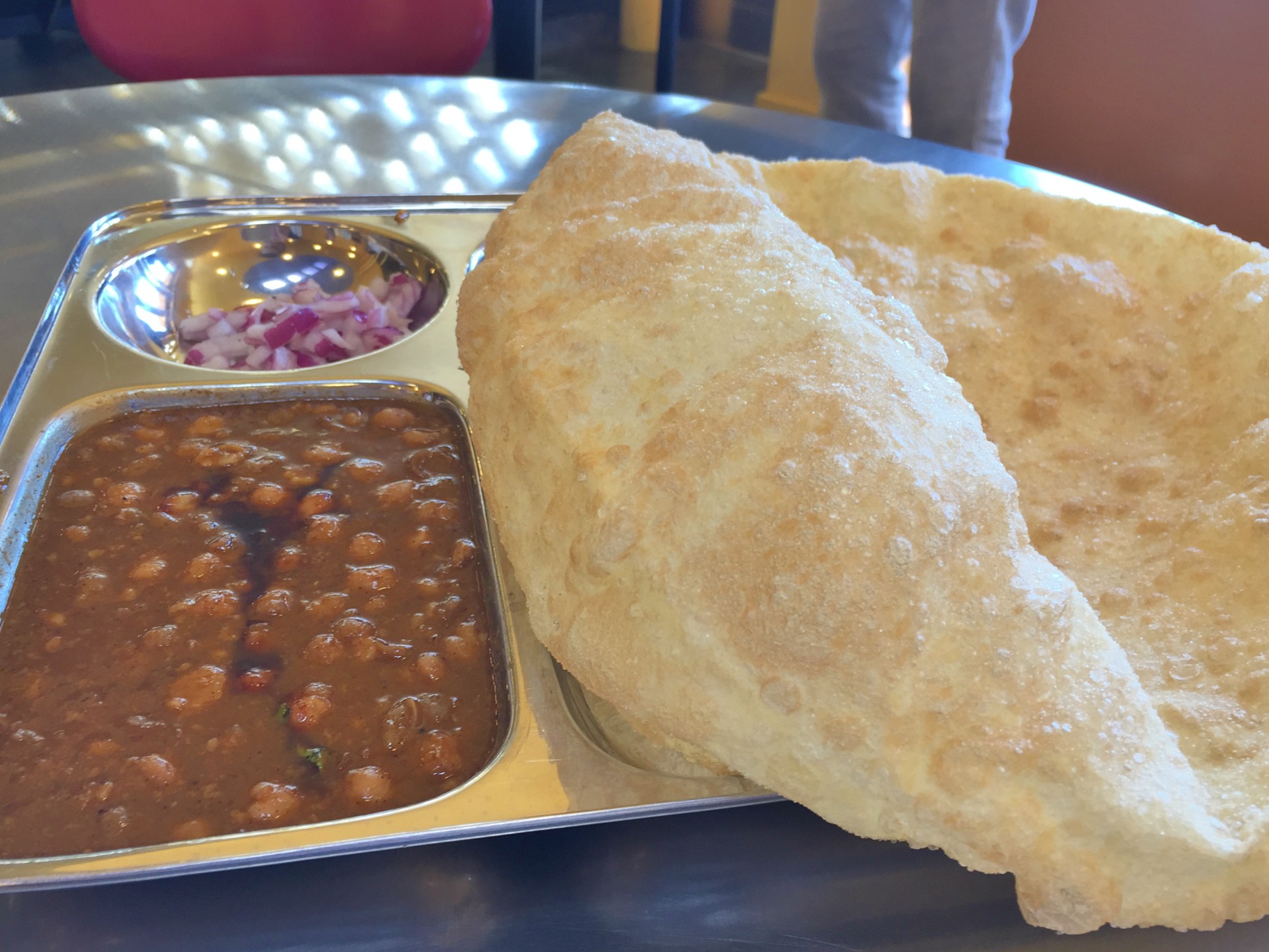 The rapidly-deflating cholle bhature makes a perfect vehicle for scooping up chana masala.