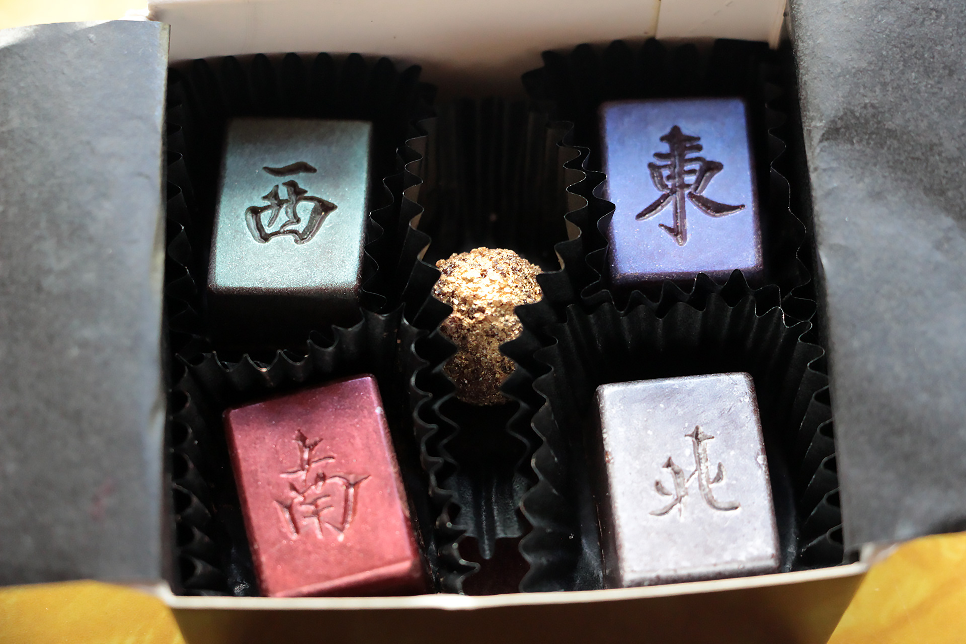 Chocolates stamped with symbols representing the four winds.