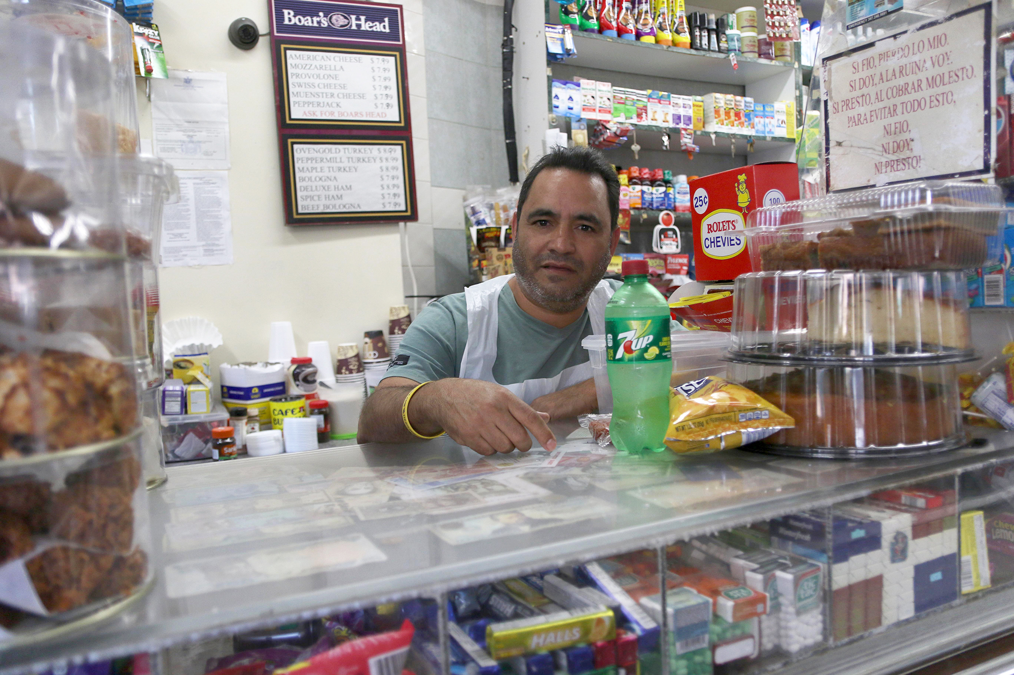 Bolivar Mena manages the Mini Market in Queens frequented by writer Angely Mercado. He always greets his customers and does his best to manage morning and afternoon rushes.