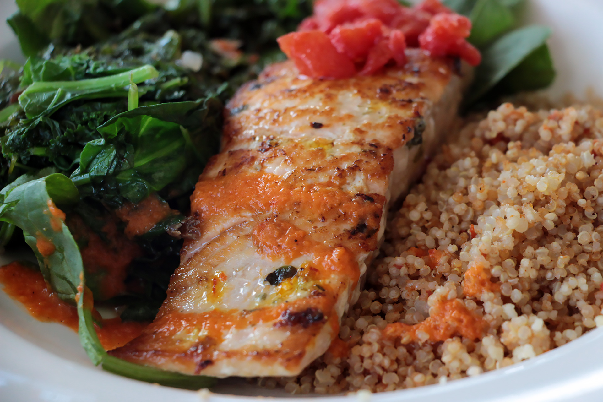 Wild salmon comes simply with quinoa and cooked spinach.