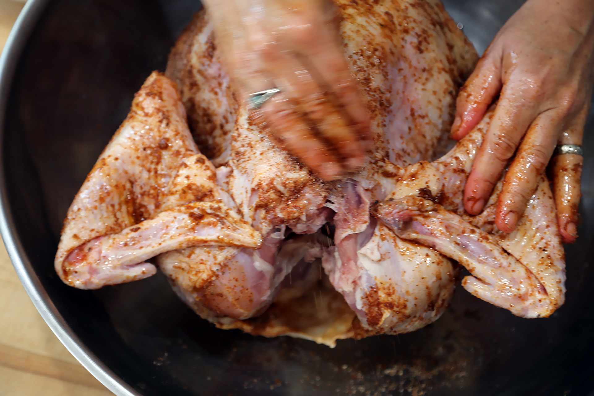 Spread the oil over the whole turkey, so the rub sticks and becomes pastelike. Tuck the wing tips under the turkey