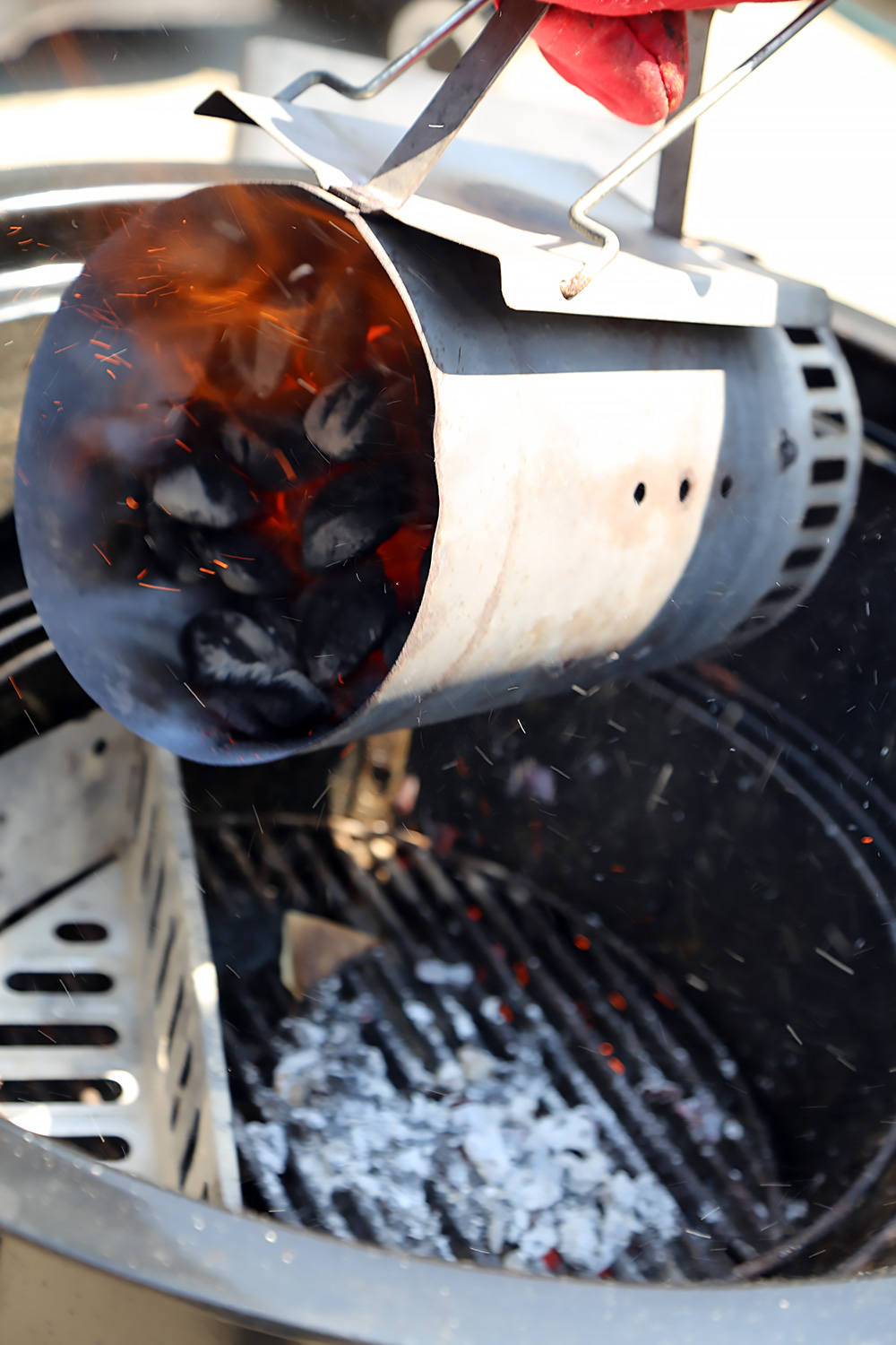 When the charcoal is lit and grey, pour it into a charcoal smoker or a charcoal grill, on one side of the charcoal grate (or in a coal box), arranging the coals in a mound.