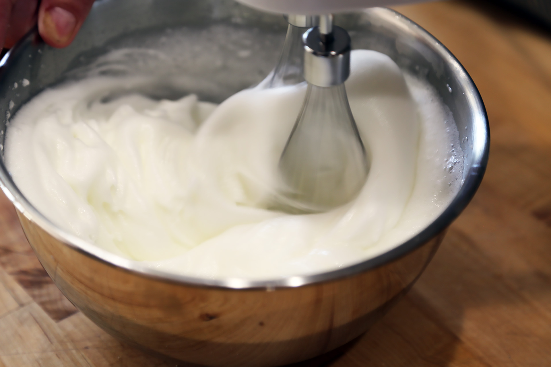 In mixing bowl using an electric mixer fitted with the whisk attachment, whip the egg whites to medium-stiff peaks.