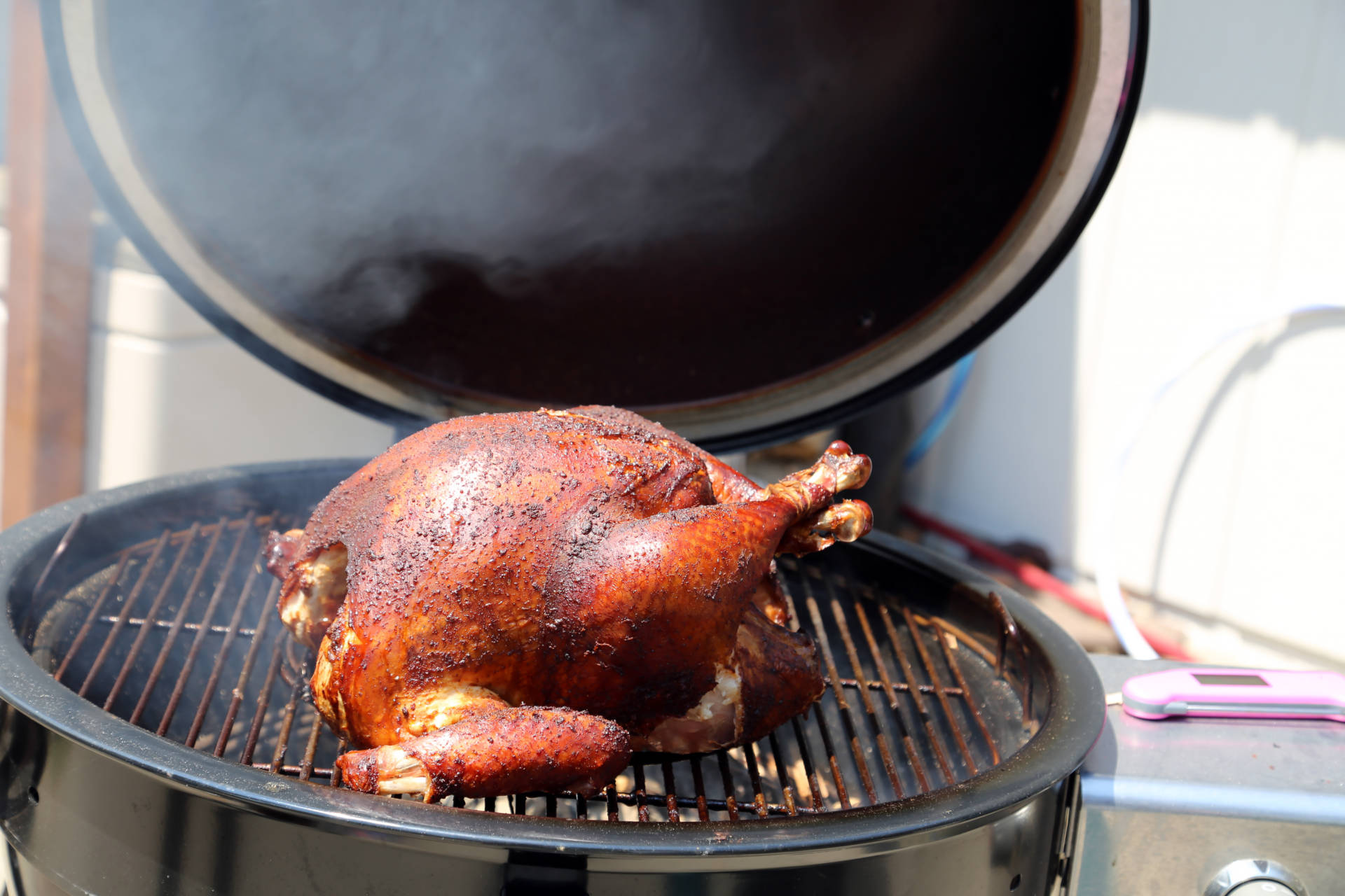 Prepare a Thanksgiving turkey in a smoker.