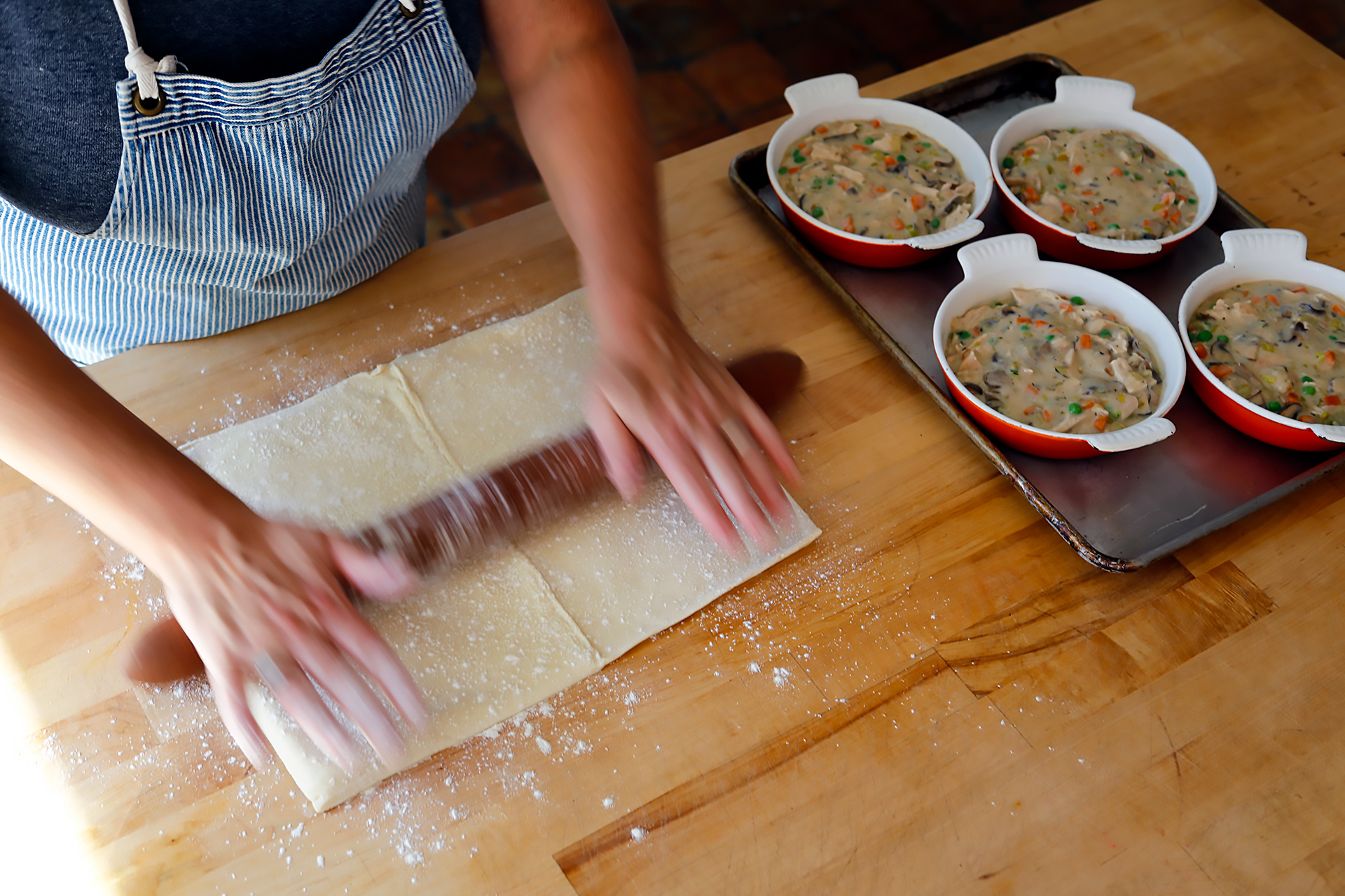 Roll out the dough to make an even surface for the pie tops.