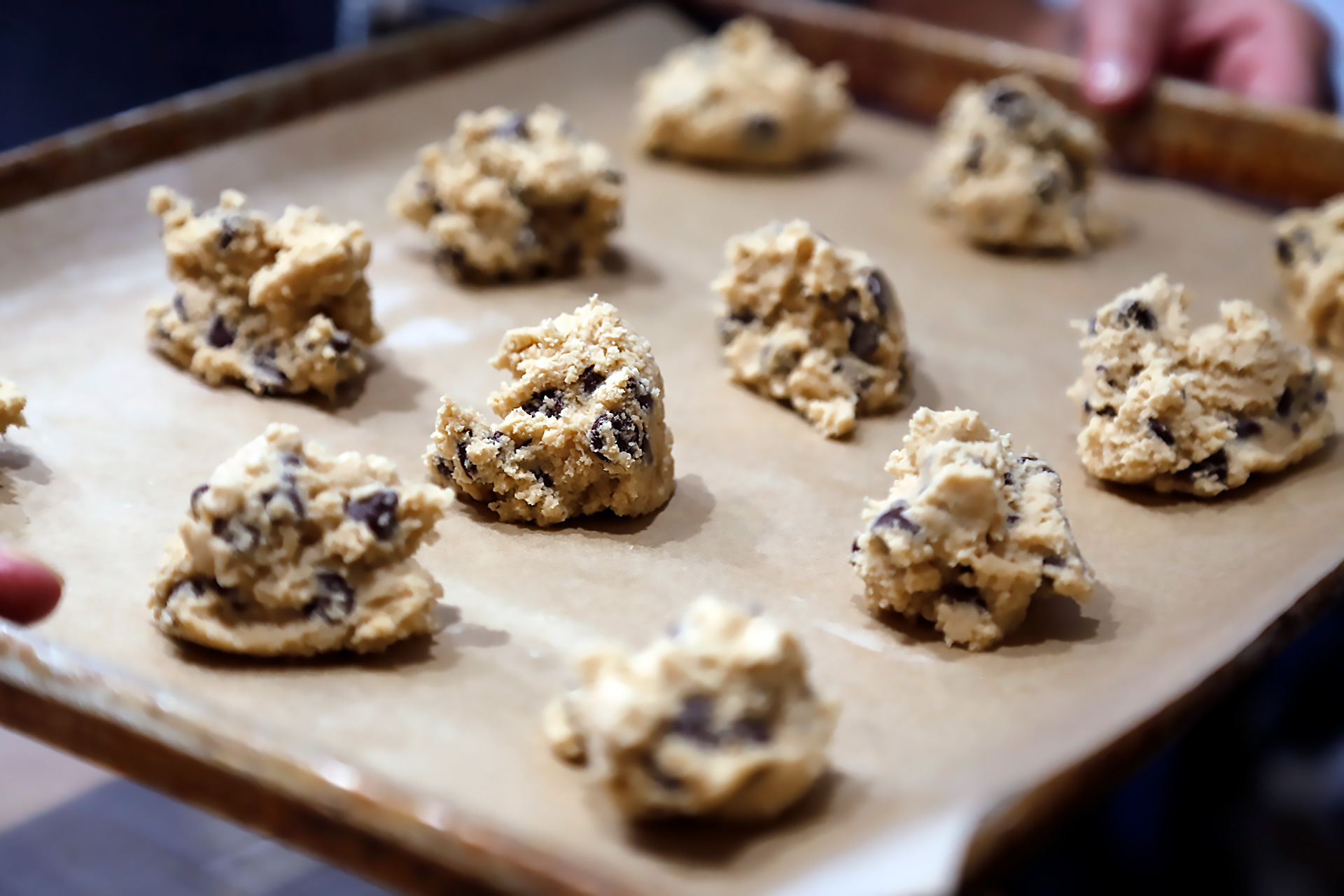 Drop the dough by heaping tablespoonfuls onto the baking sheet, spacing them evenly.