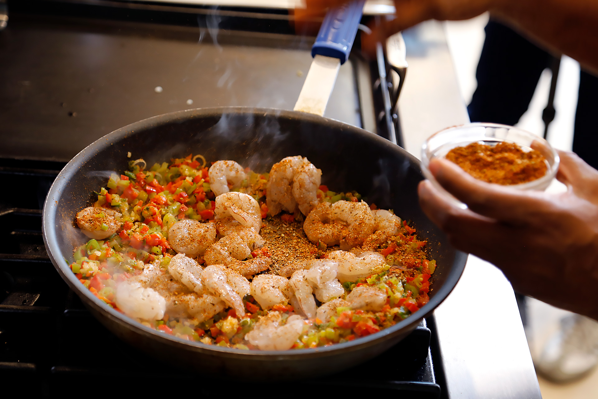Turn shrimp and sprinkle with Creole spice then sauté until vegetables are softened, about five minutes.