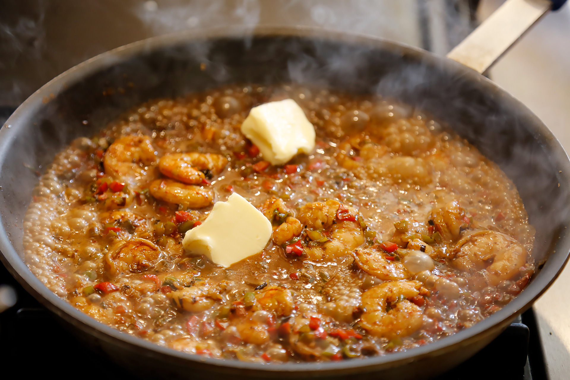 Add Creole sauce and cream, and bring to a simmer. When shrimp are cooked through, add butter and lemon juice.