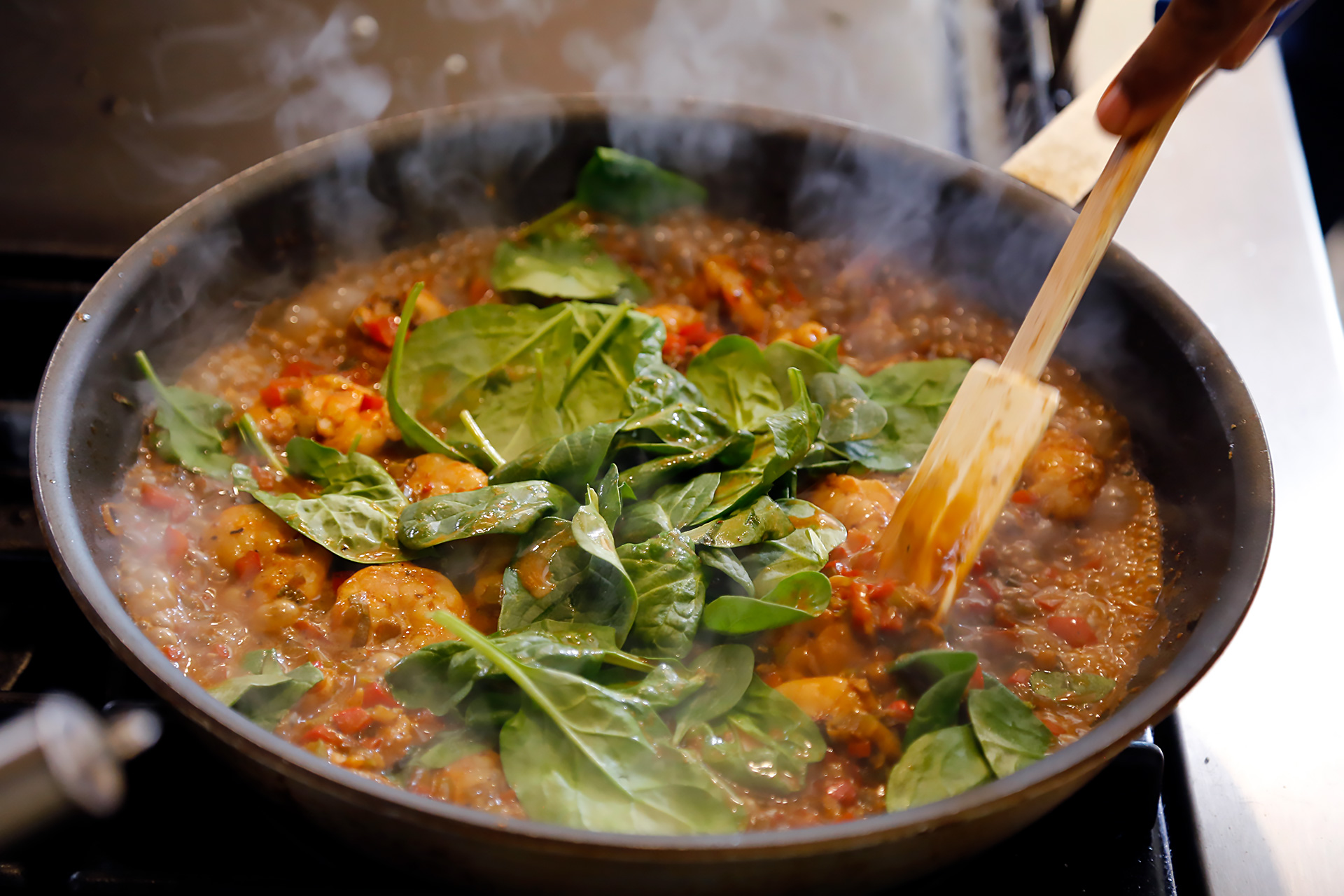 Stir to coat with sauce and wilt the spinach.
