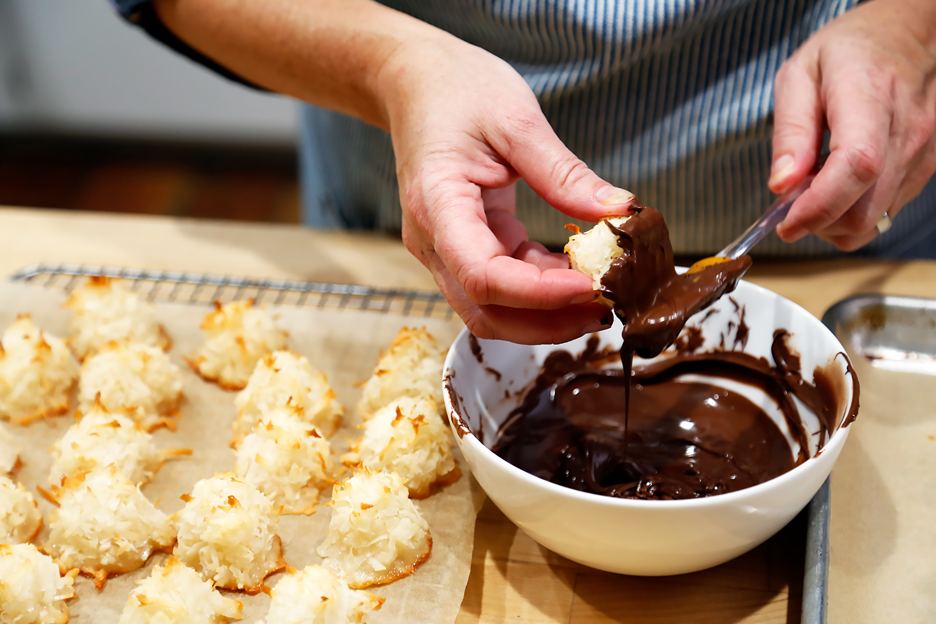 Dip the bottom of each macaroon into the melted chocolate (scraping any excess off with a little rubber spatula or a spoon if you like) then place, chocolate side down, on the baking sheet.