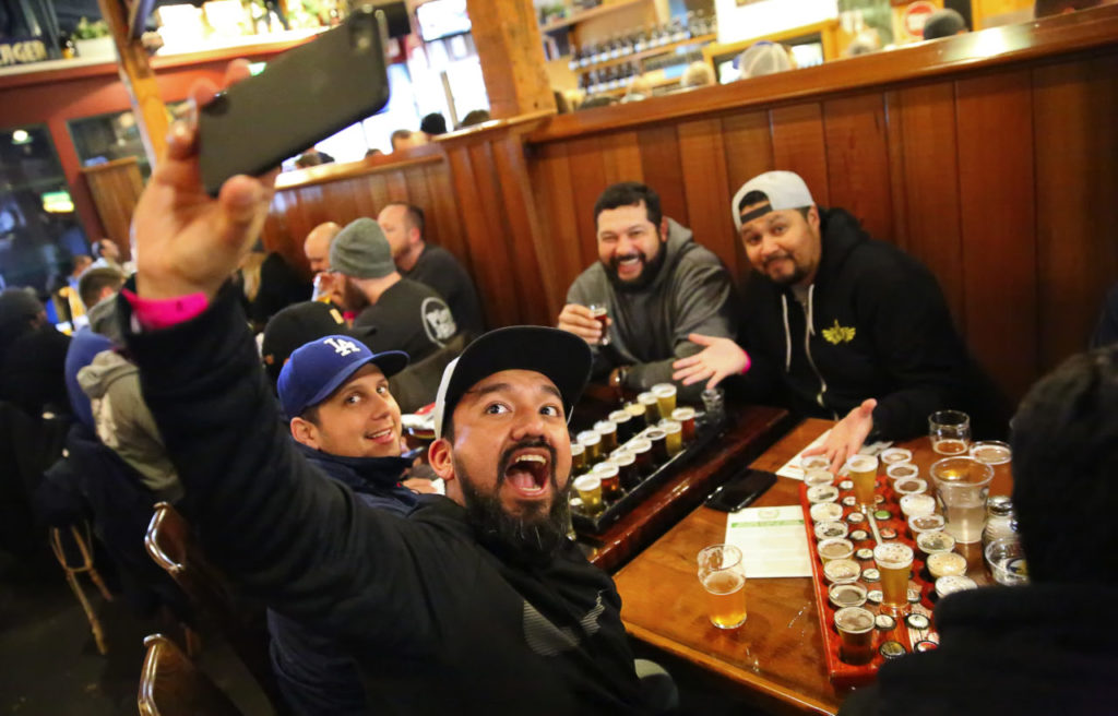 Victor Arrazabal, foreground, shoots a selfie with Sergio Guadron, left, Hernan Tobar, and Victor Arana, at the Russian River Brewing Company in 2017.  The friends travelled from Los Angeles for the annual release of Pliny.