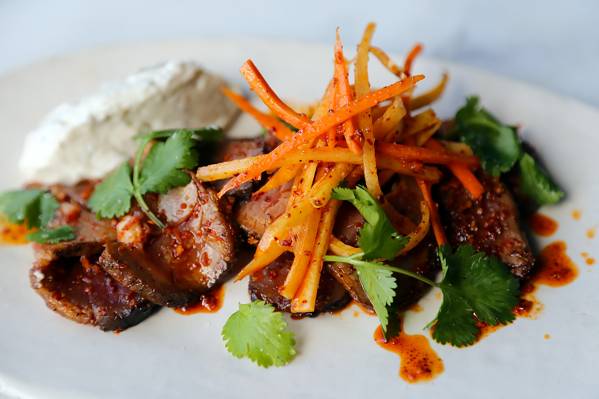 Lamb leg with peppercorn labneh and carrot salad