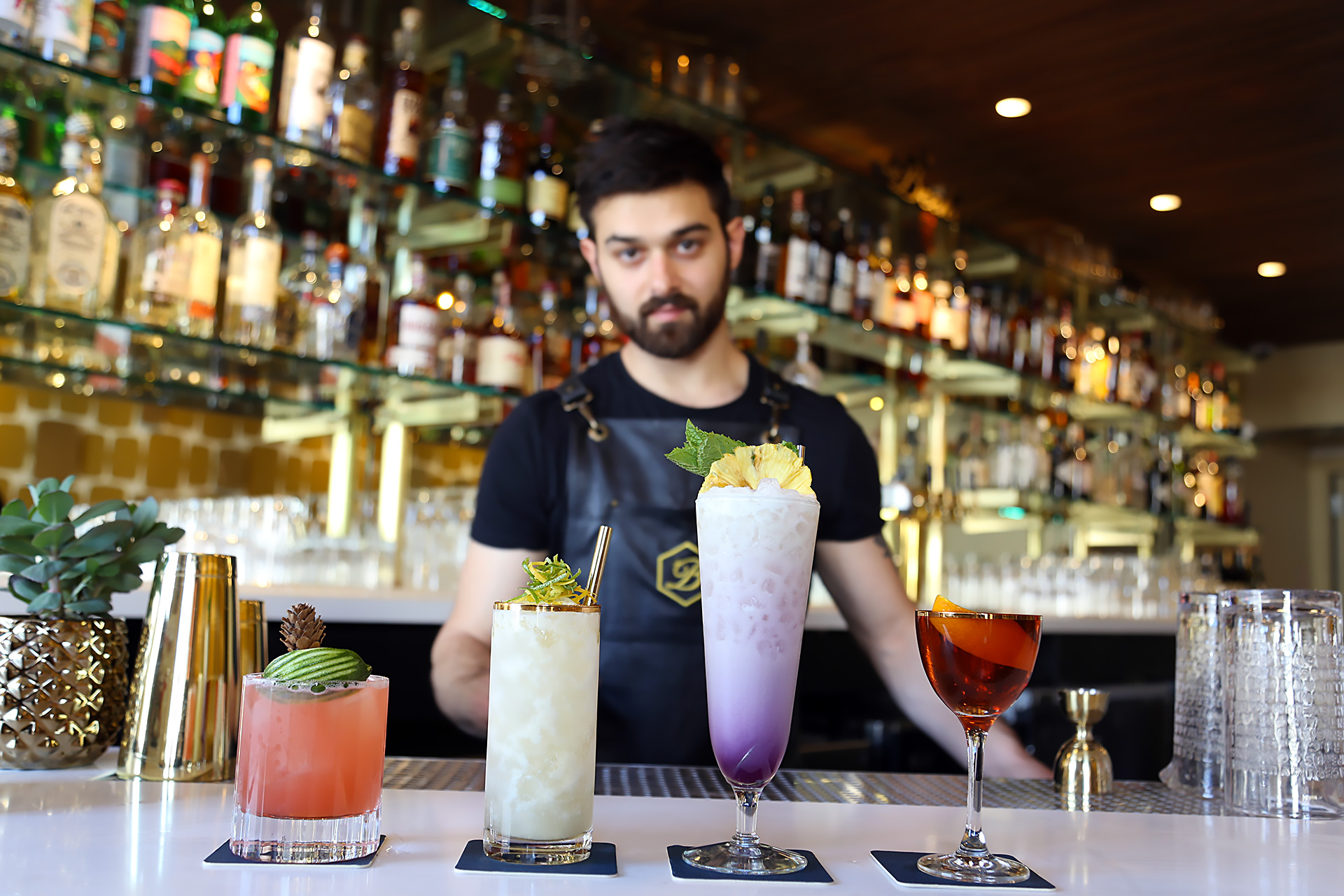 Lead Bartender Emilio Salehi showcases The Beehive cocktails (L to R): Thunderbird, Ipanema Gold, Bikini Drifter, Rising Sun