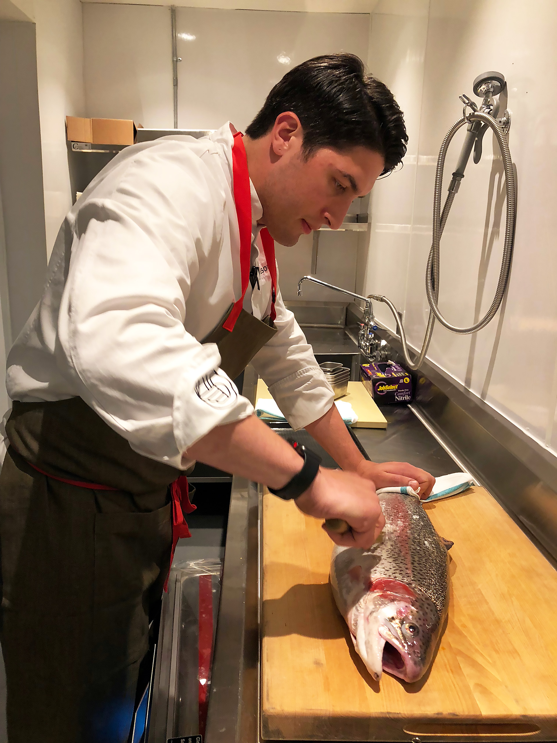 Chef de cuisine Brian Limoges prepping a large trout