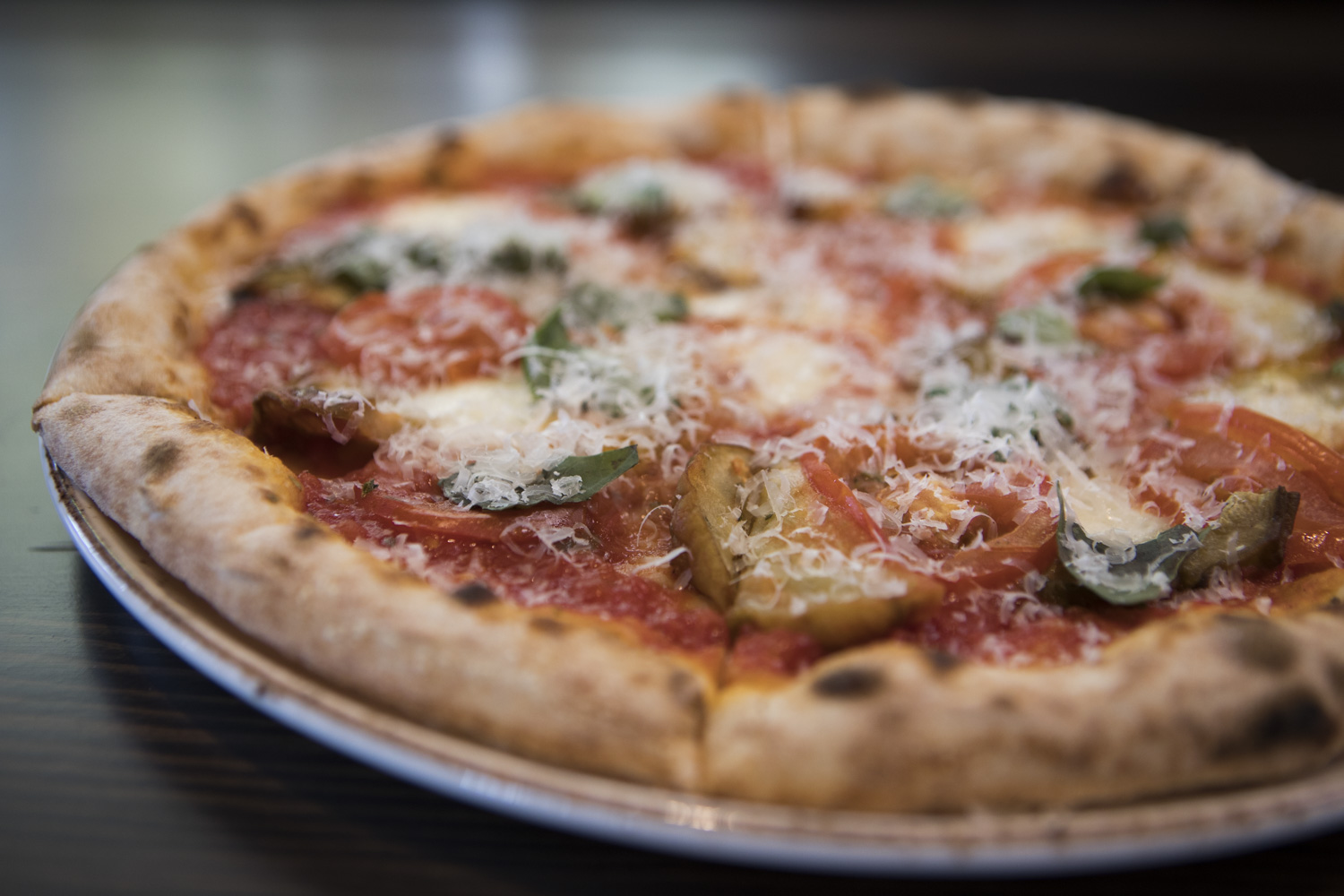The Parmigiana pizza with fresh mozzarella, eggplant, tomatoes, oregano, basil, Parmigiano-Reggiano. 