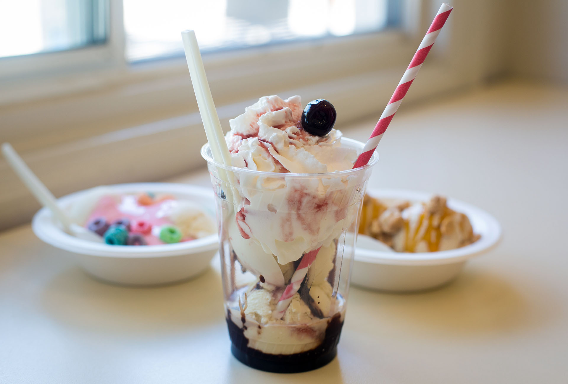 The Hot Mess Sundae, made with vanilla ice cream, butter scotch, marshmallow fluff, and topped with a cherry.