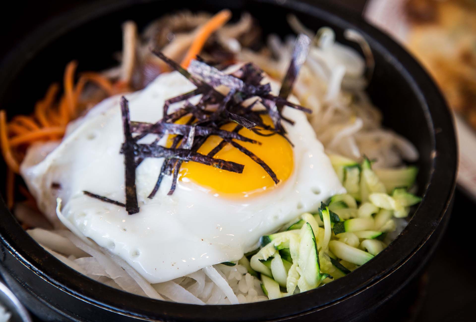 A traditional bibimbap served in a hot stone bowl