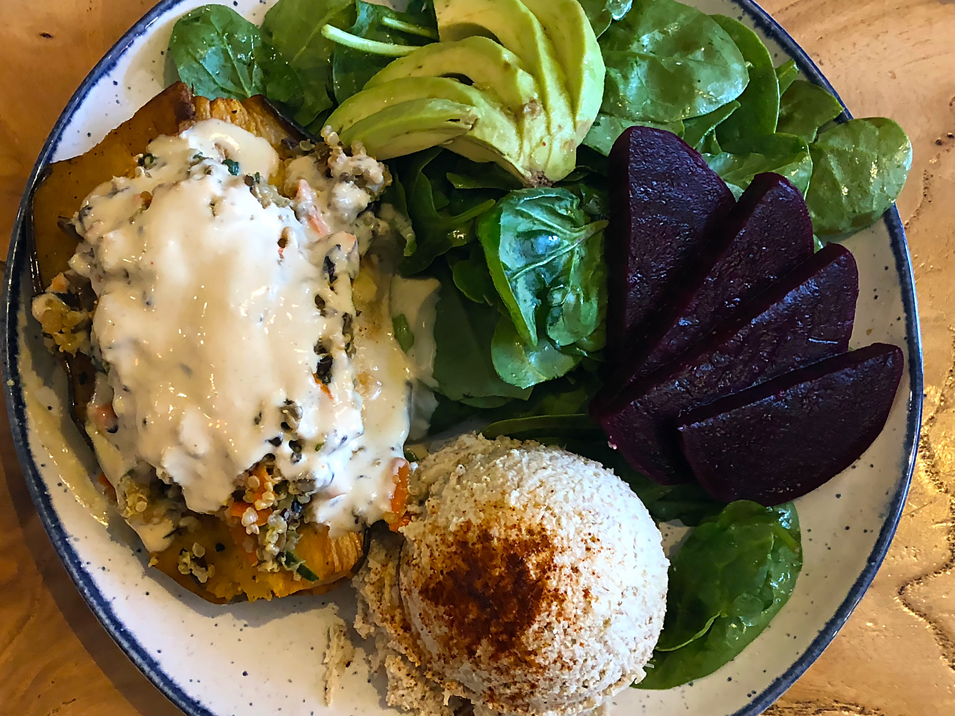Beloved's Stuffed Delicata Squash ($14): roasted delicata squash stuffed with homemade superfoods quinoa salad, topped with tahini dressing, spinach salad, avocado, beets and hummus.