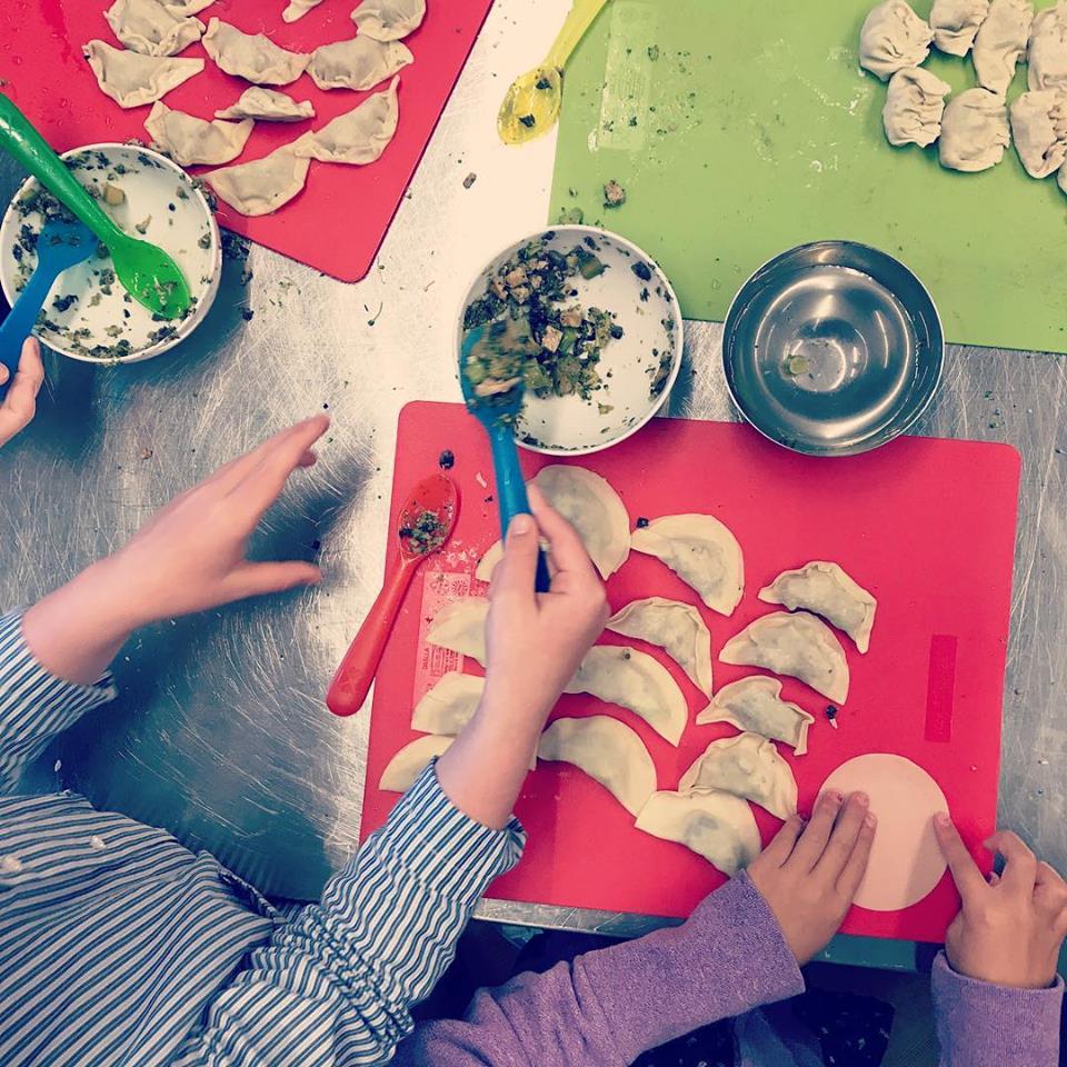 Children learn how to make their own pot stickers.