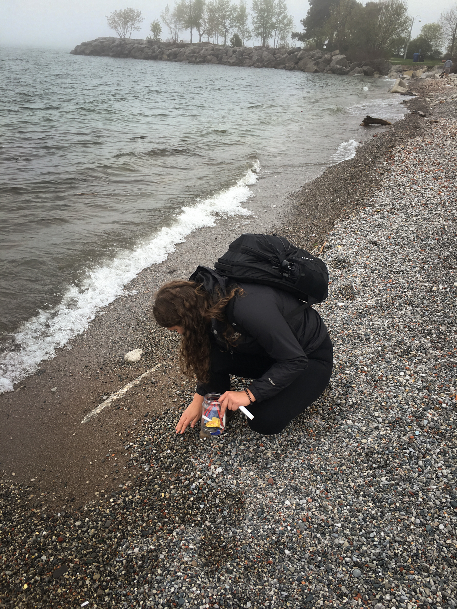 Researcher Kennedy Bucci collects plastics from the shore of Lake Ontario in Toronto.