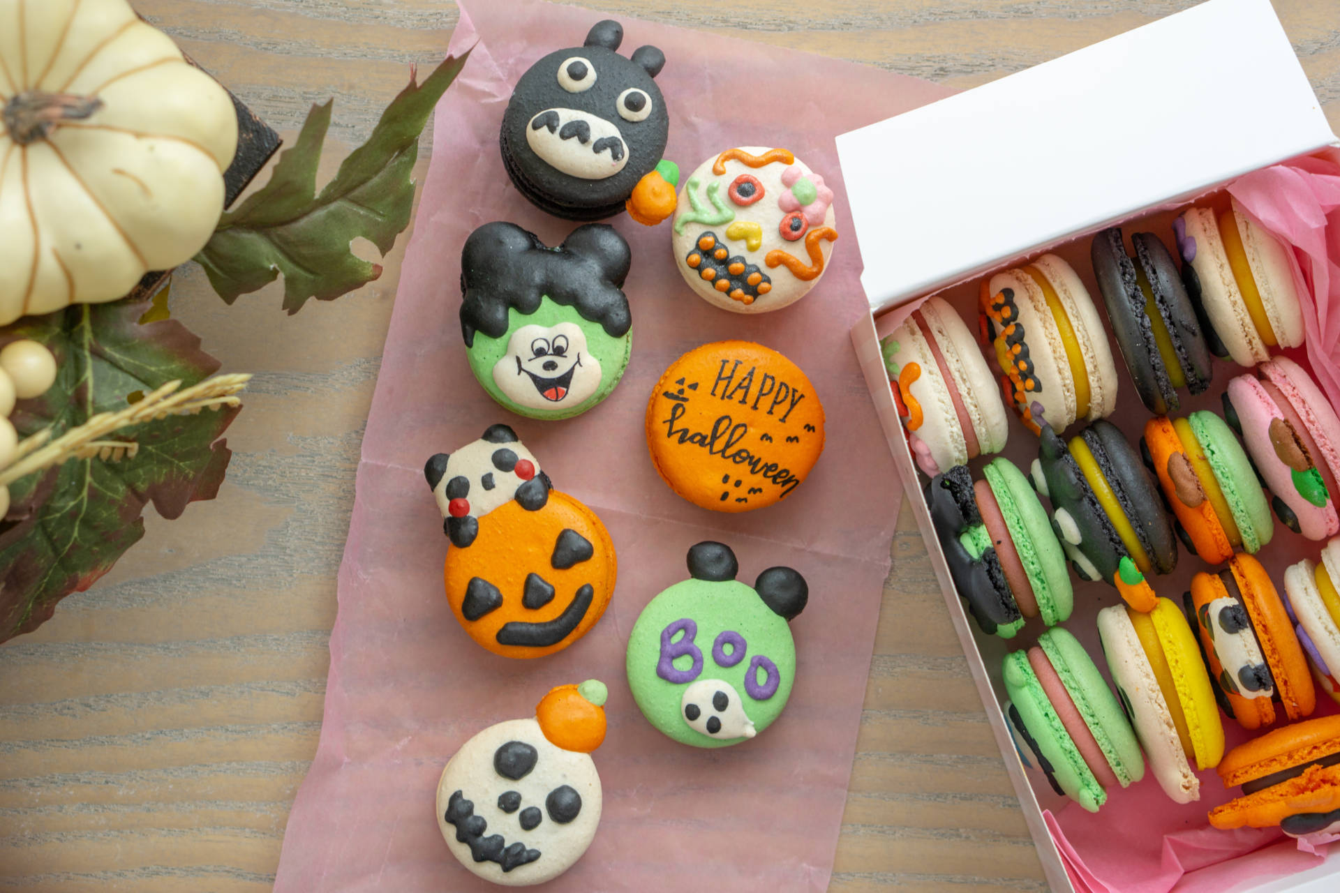 An assortment of Halloween macarons in guava, strawberry, chocolate, mango and more.