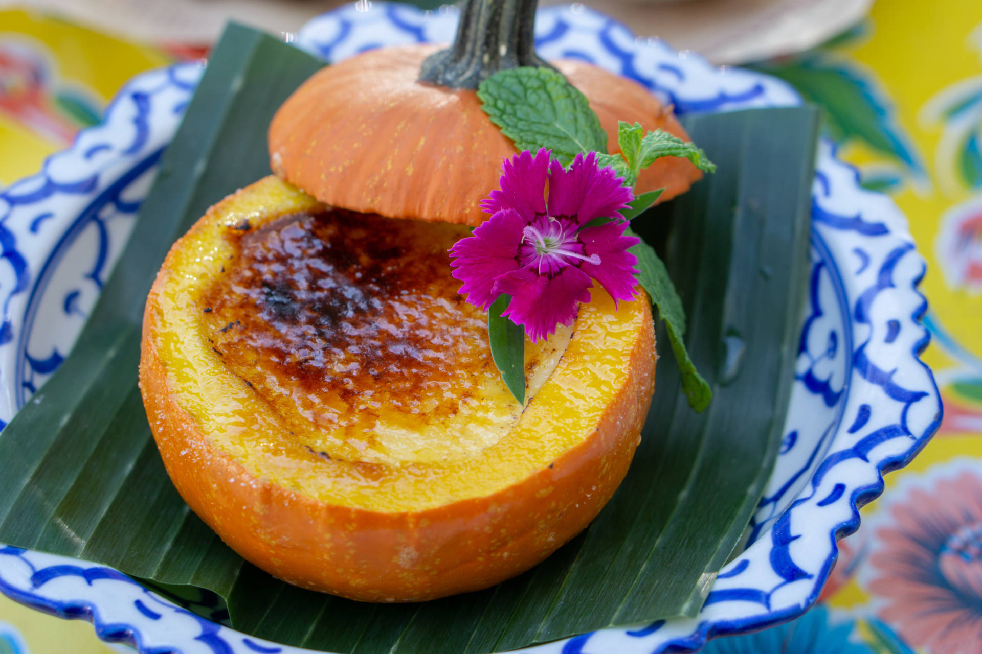 Pumpkin Creme Brulee is served up in a real pumpkin, dainty and delicious.