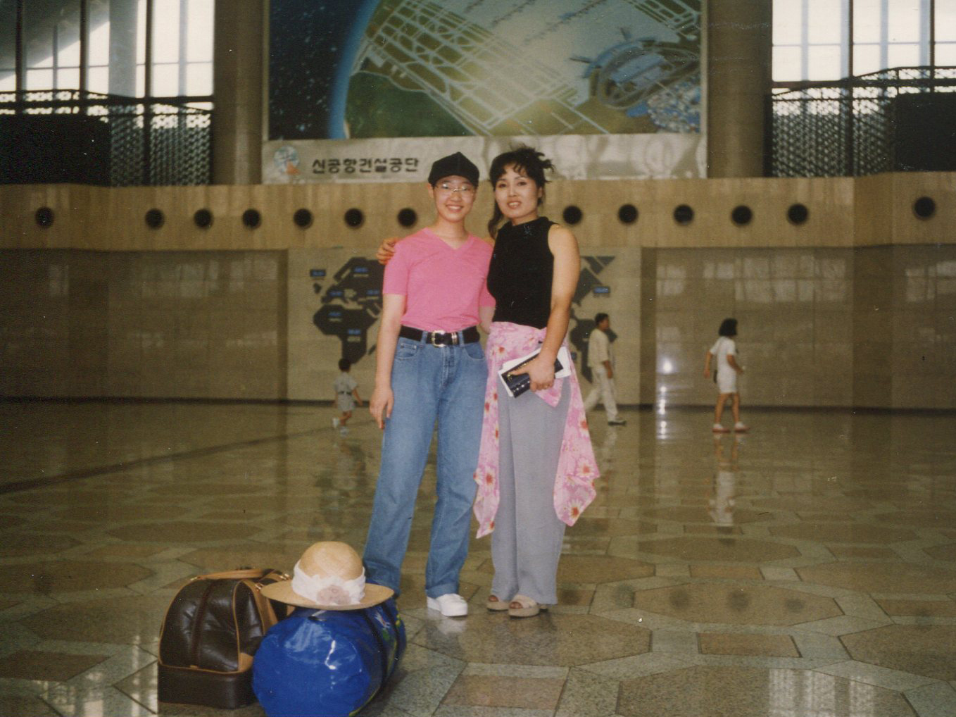 Robin Ha and her mother, Cassie, at an airport in South Korea, on their way to the U.S., in 1995.