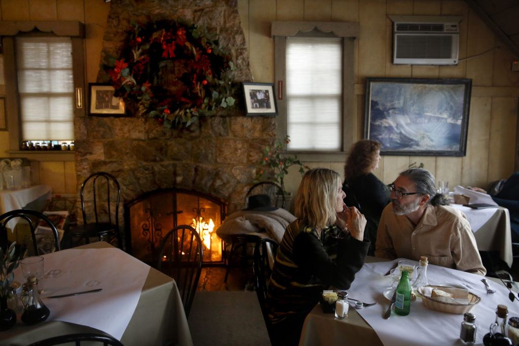 A fire burns in the dining room of Cafe Citti in Kenwood, on Monday, December 21, 2015.