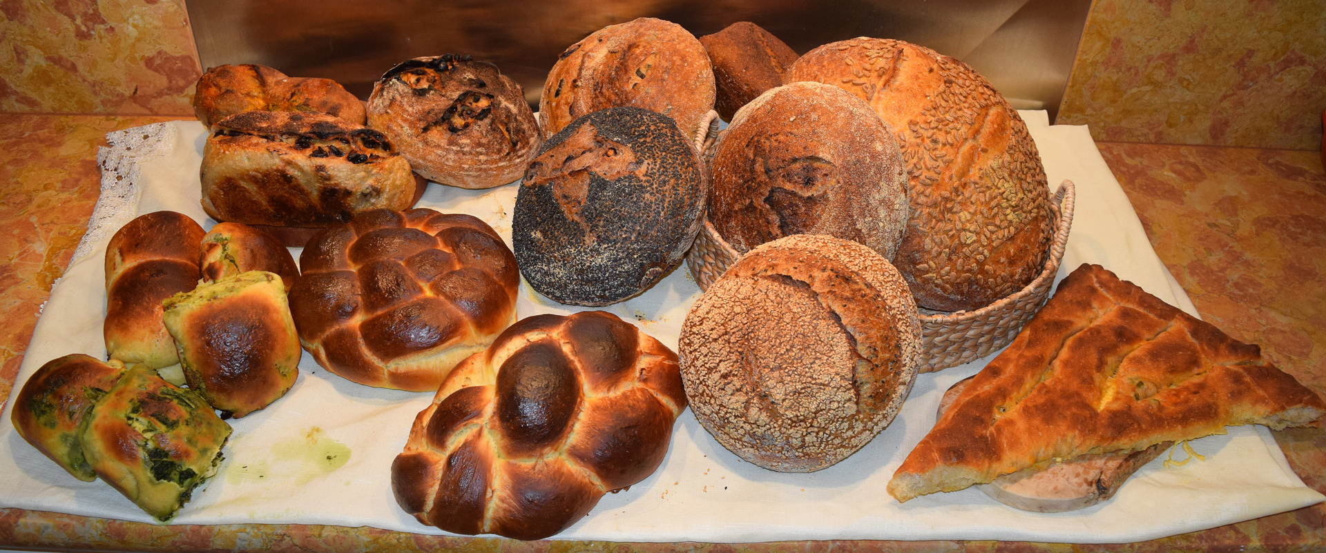 Country breads, challah, filled rolls, fougasse and other kinds of breads are made by hand in Little Sky Bakery's kitchen workshop.