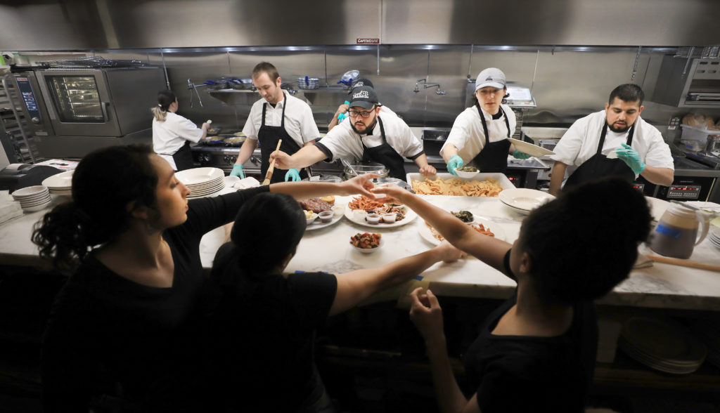 During a soft opening for Sweet T's in Windsor, Monday, March 4, 2019 the chefs and servers prepare meals for their customers.