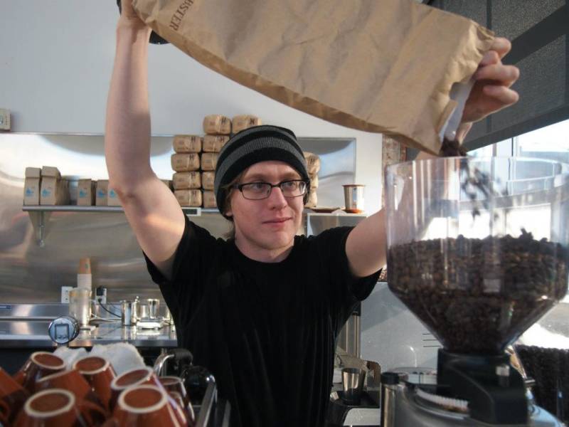 evan gilman pouring coffee beans