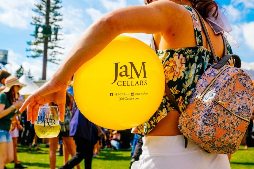 BottleRock attendee with JaM Cellars balloon and wine.