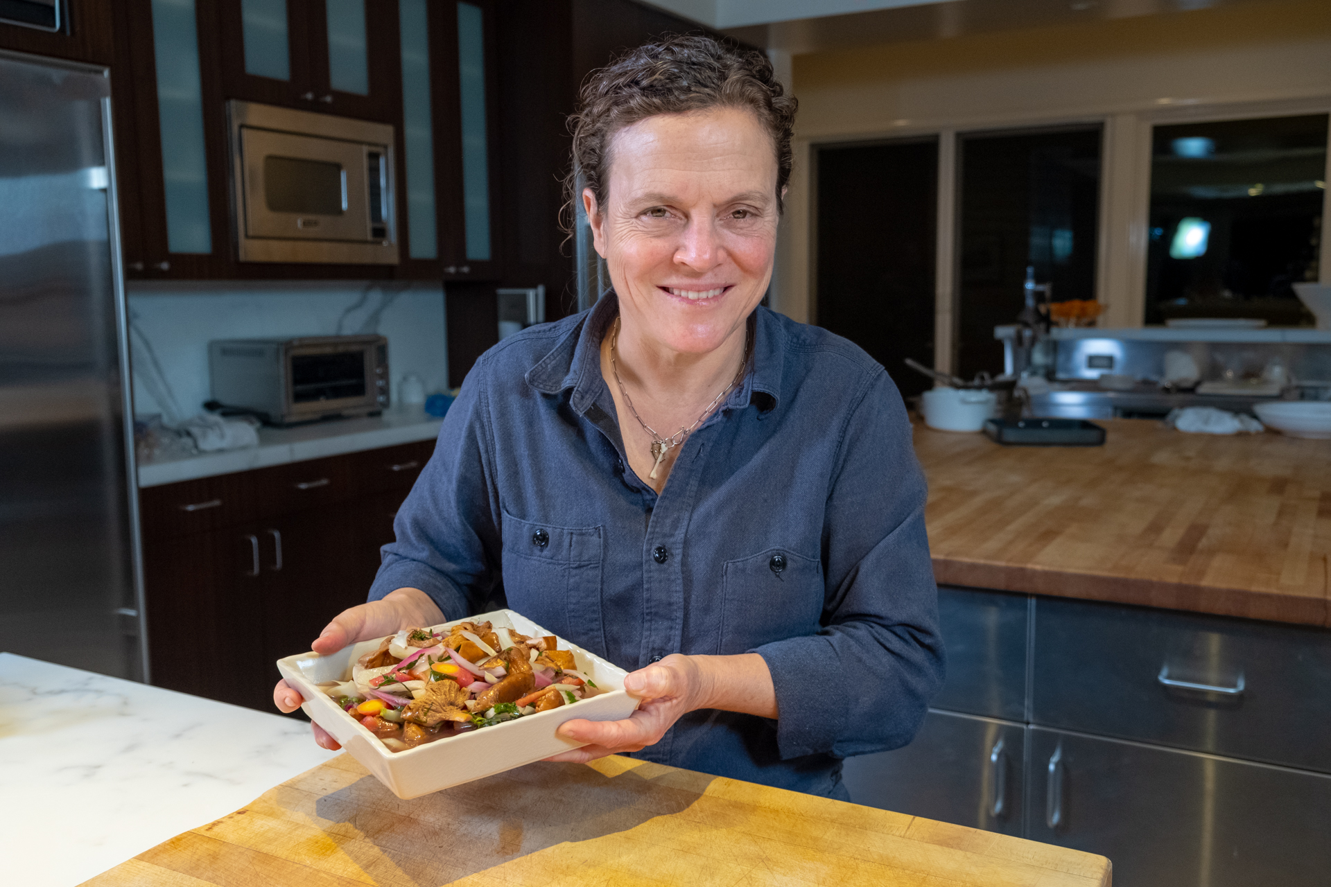 Traci Des Jardins with a plate of her Quick Pickled Spring Mushrooms and Vegetables.