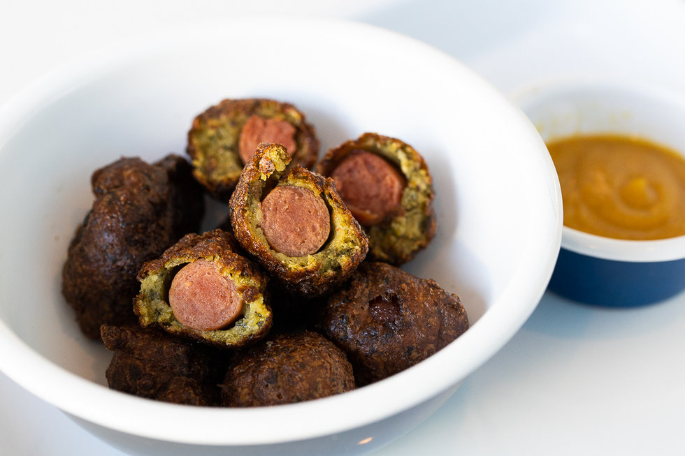 These corn dog bites have been given the Aaron London treatment: an upgrade from traditional corn dog breading to a variation made with tasty falafel.