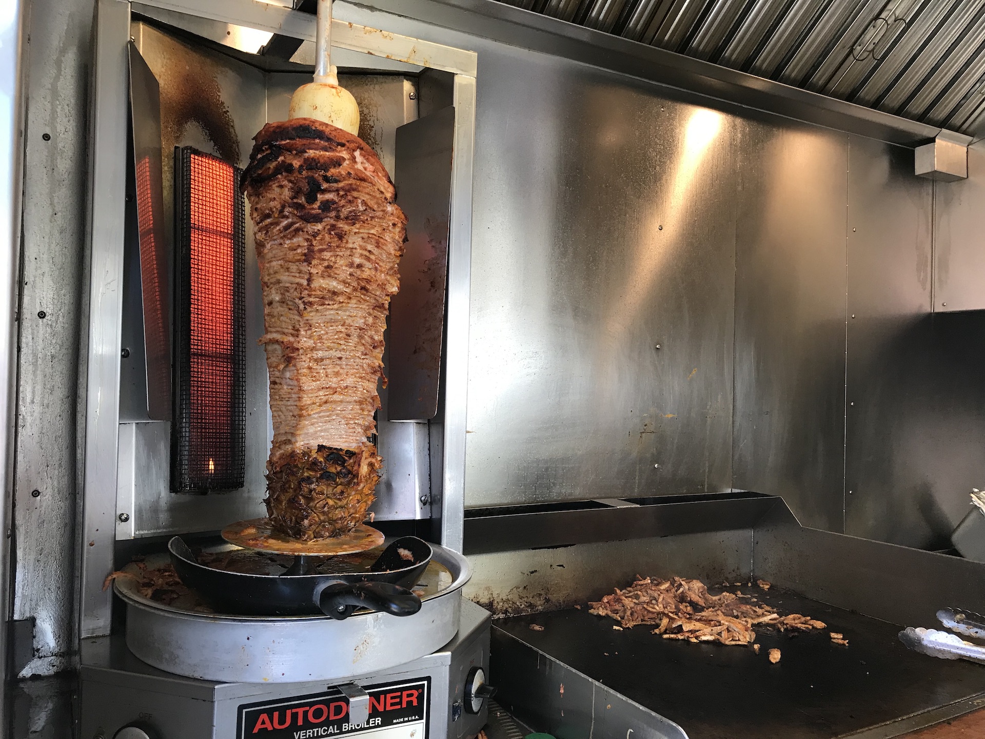 A trompo is a vertical grill in which the pork meat for al pastor tacos is slowly cooked.