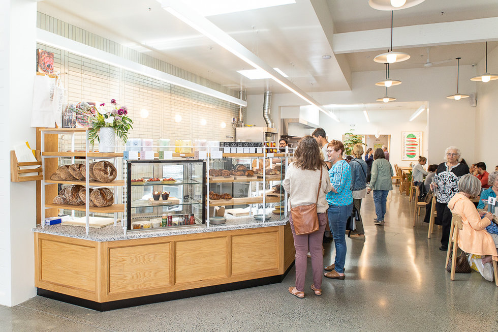 Make your way past the exterior courtyard to the counter laden with pastries. Pick a few, order a coffee, and grab a hot meal item to indulge in.