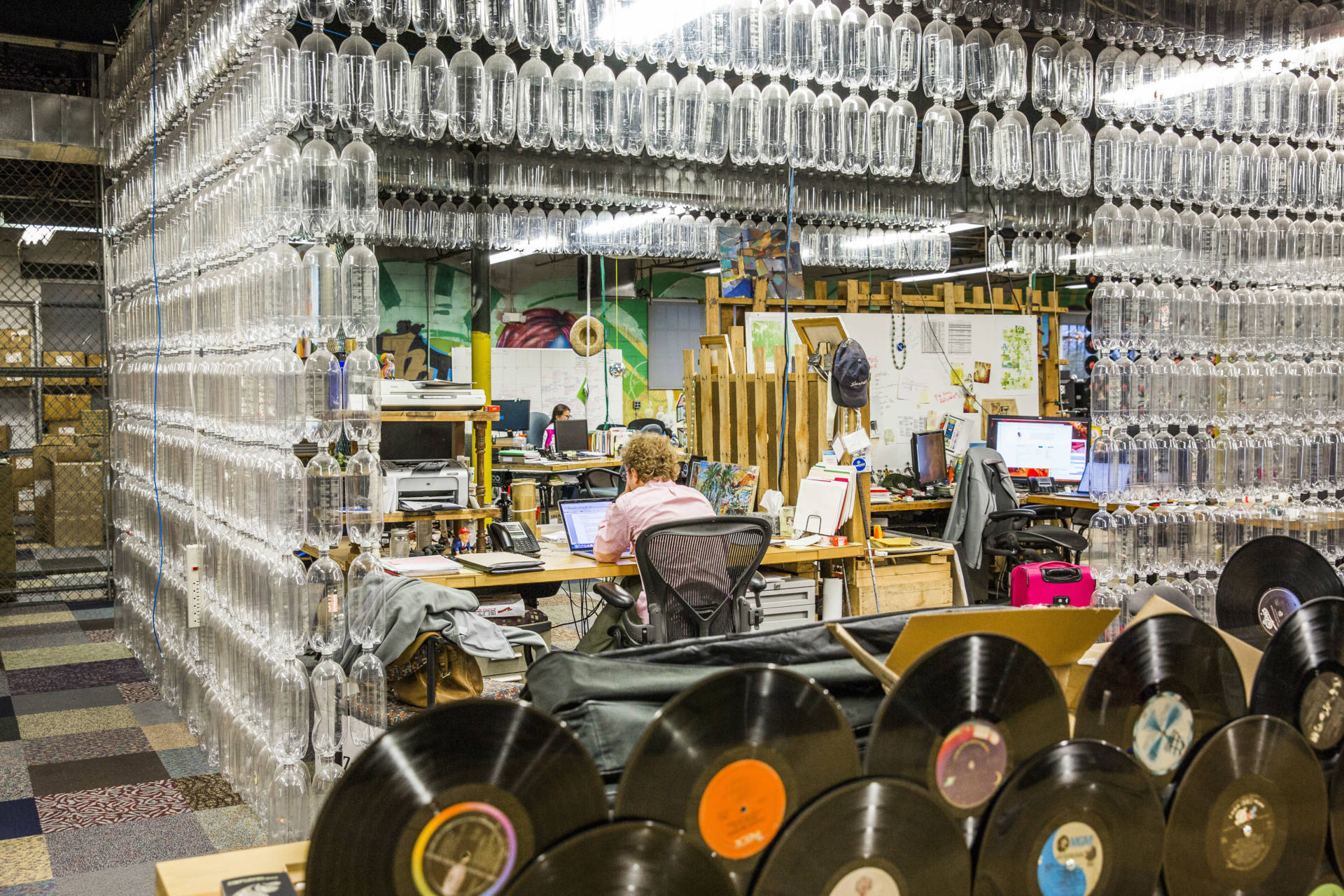 Plastic bottles surround an employee at a workstation inside recycling company TerraCycle's headquarters in Trenton, N.J., in 2017.