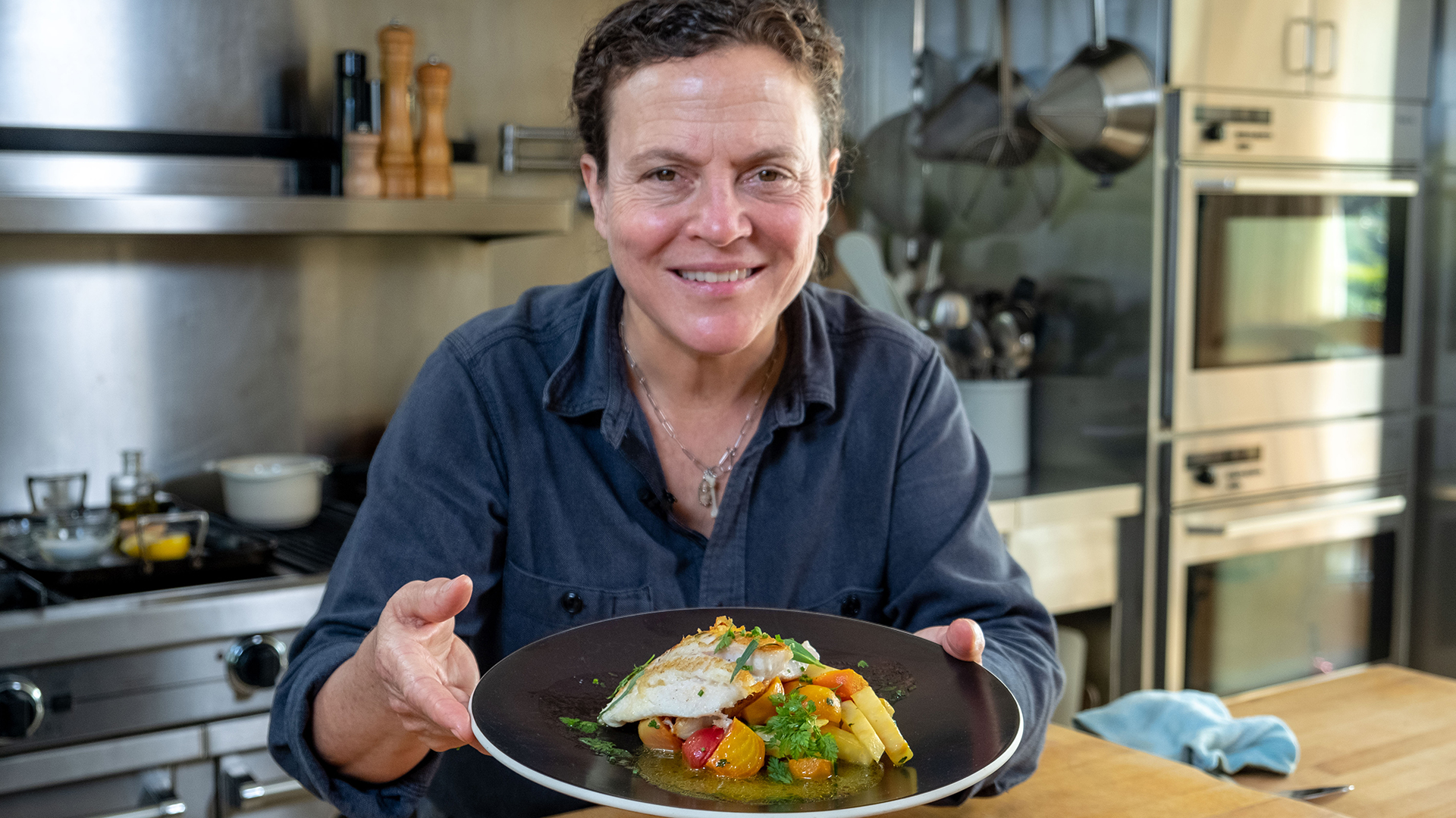 Traci Des Jardins holds a plate of her Petrale Sole with Braised Celery Root and Roasted Beets