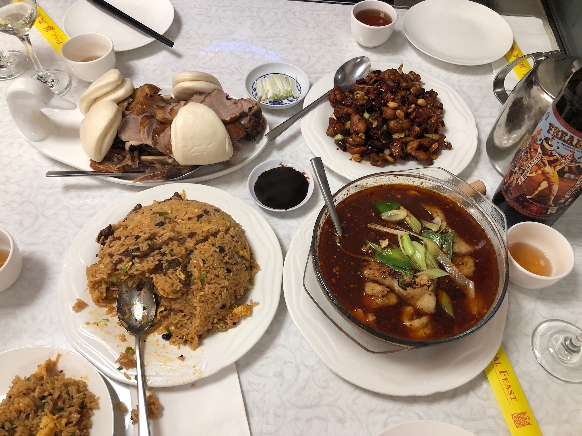 The feast is under way with a table of smoked duck, fried rice, kung pao chicken and more at Millbrae’s Royal Feast.