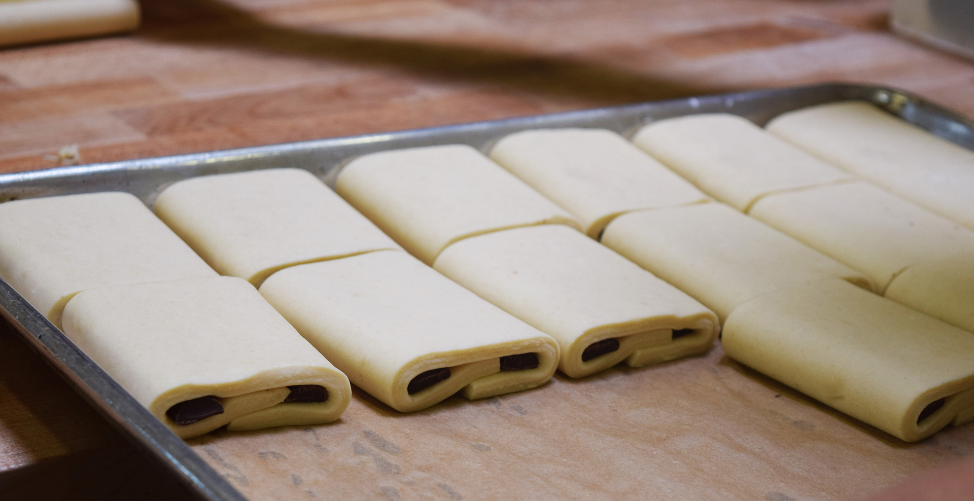 Croissants stuffed with chocolate await their time in the oven.