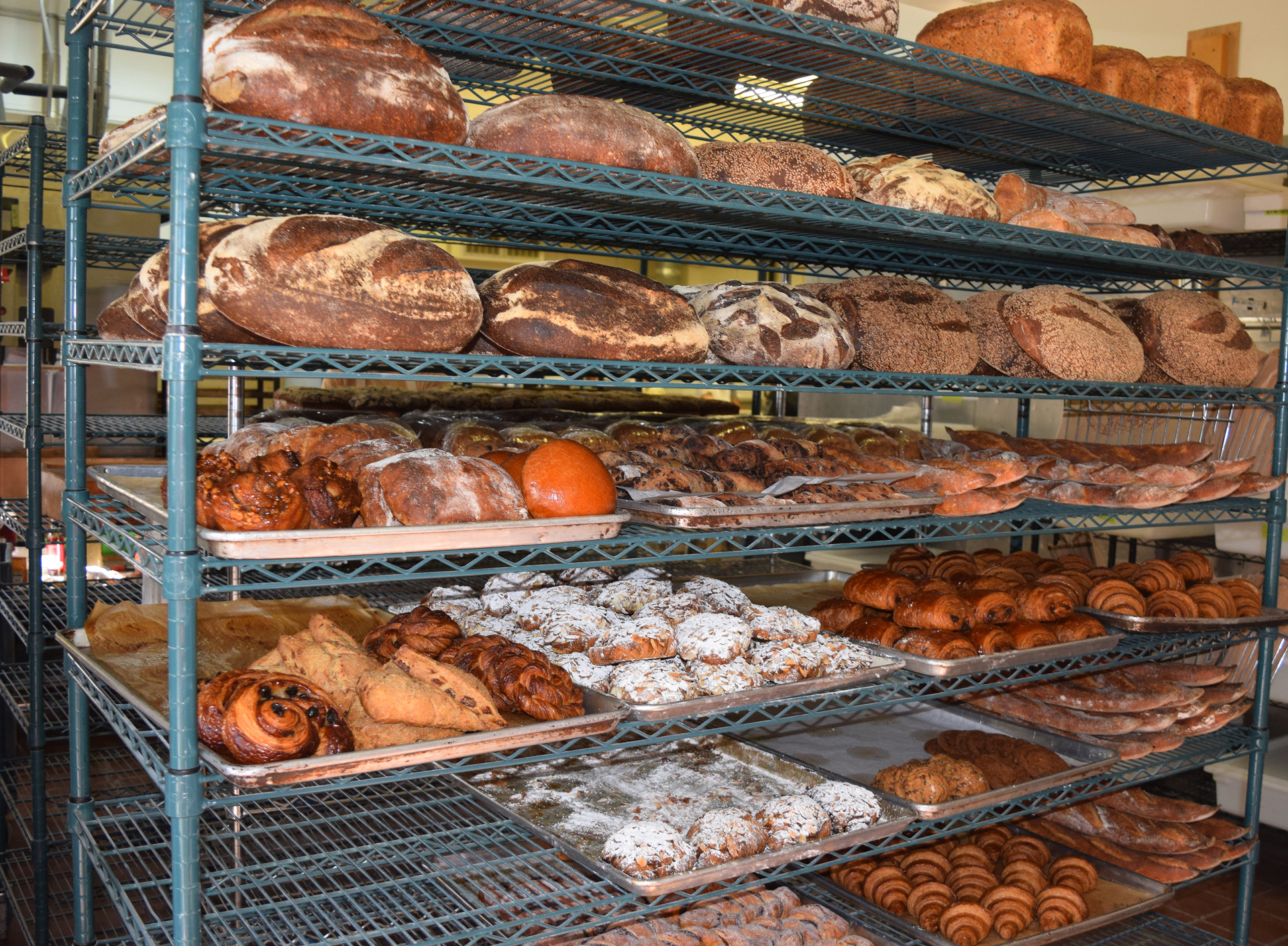 Shelves of breads and pastries inside the bakery door await morning customers.