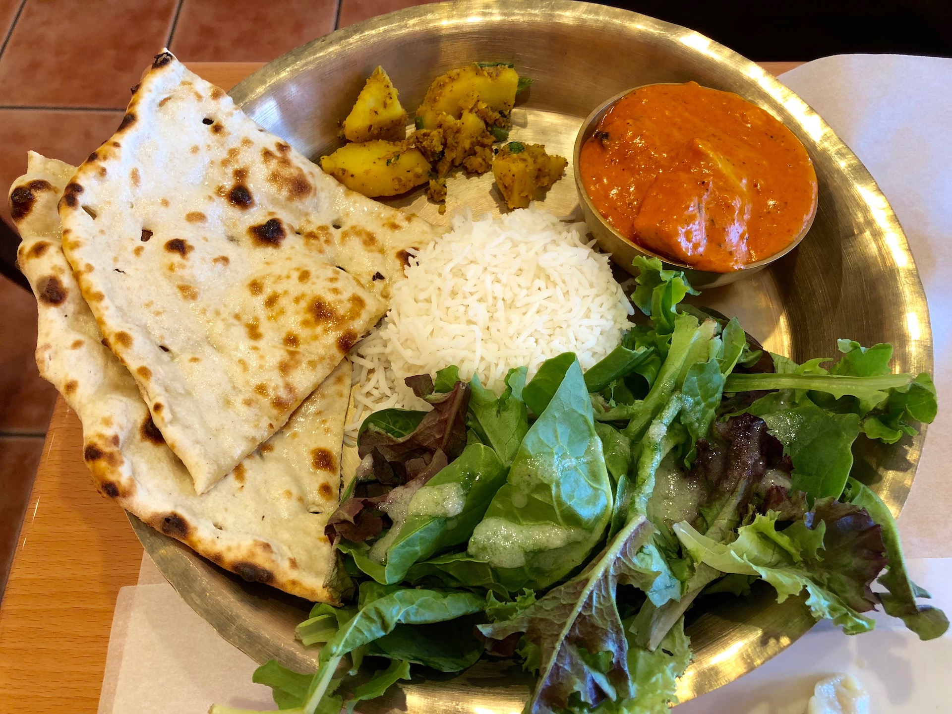 Cuisine of Nepal’s signature chicken and cashew cream curry, served as a thali platter at lunch