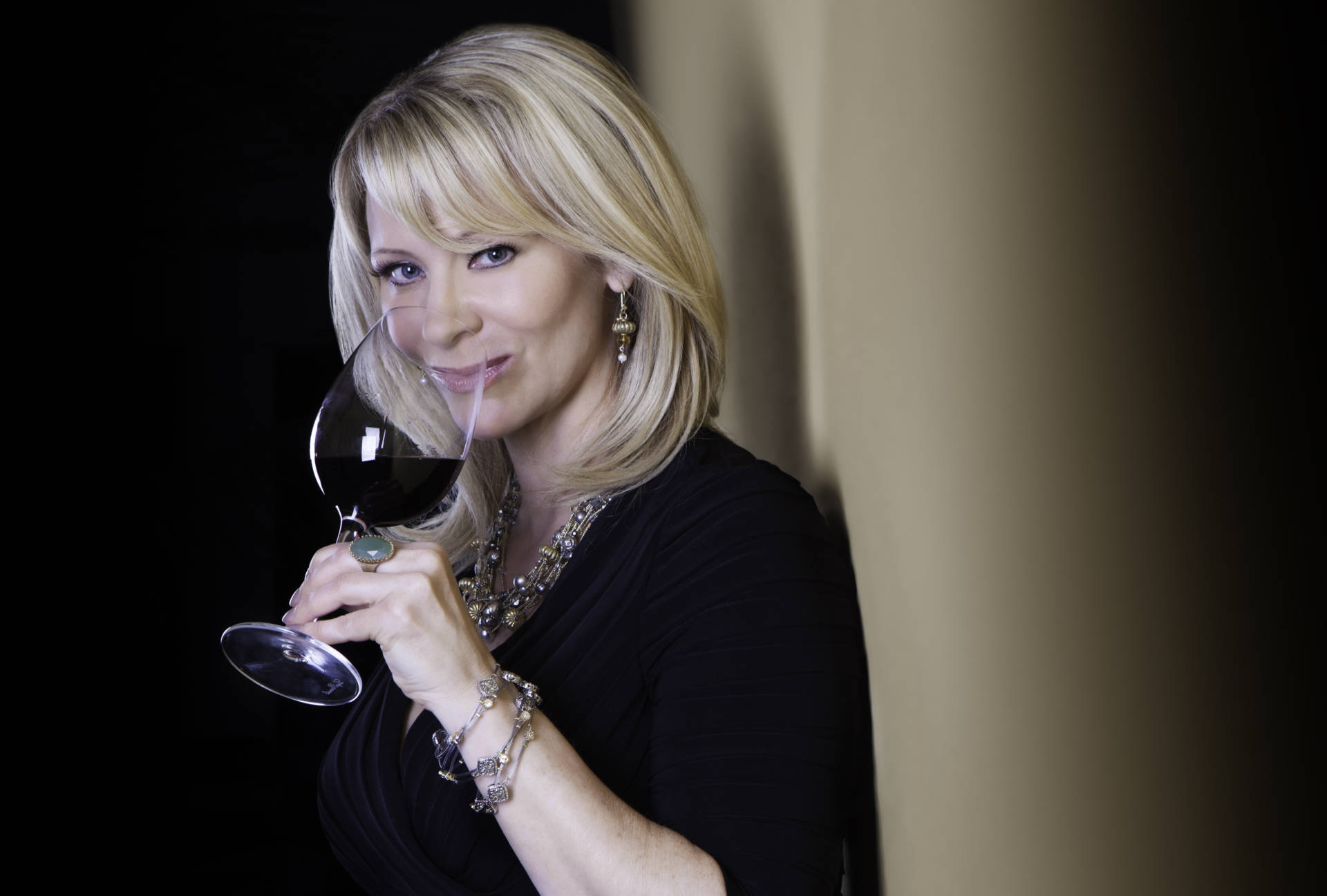 Host Leslie Sbrocco sips wine