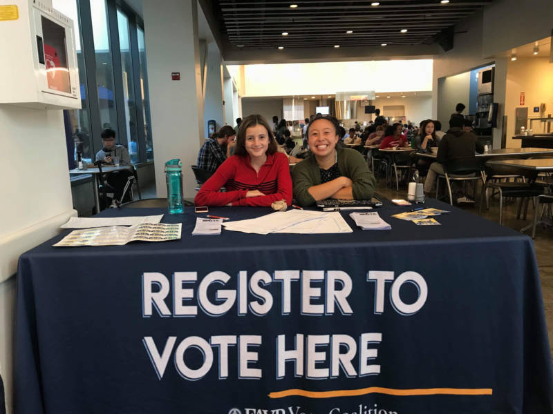 two UC Berkeley students registering people to vote for the upcoming midterm election