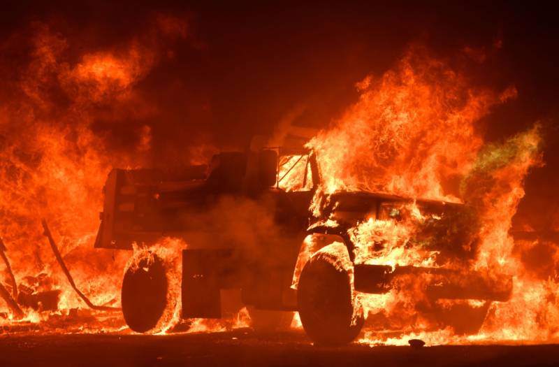 A truck burns as fire ravages the Napa wine region in California on October 9, 2017, as multiple wind-driven fires continue to whip through the region.