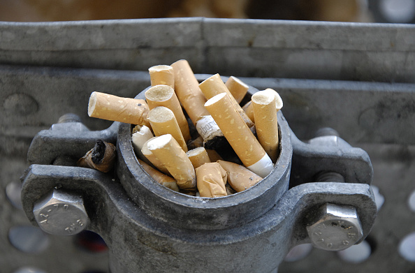 Leftover cigarettes on a bus stop waste basket in Copenhagen, Denmark. 