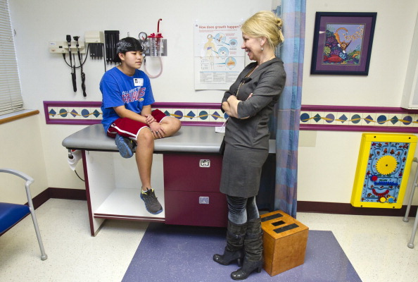 Isaac Barnett, a transgender 18-year-old, left, talks with his doctor, Jill Jacobson, Jan. 20, 2014, at Children's' Mercy South in Overland Park, Kan.